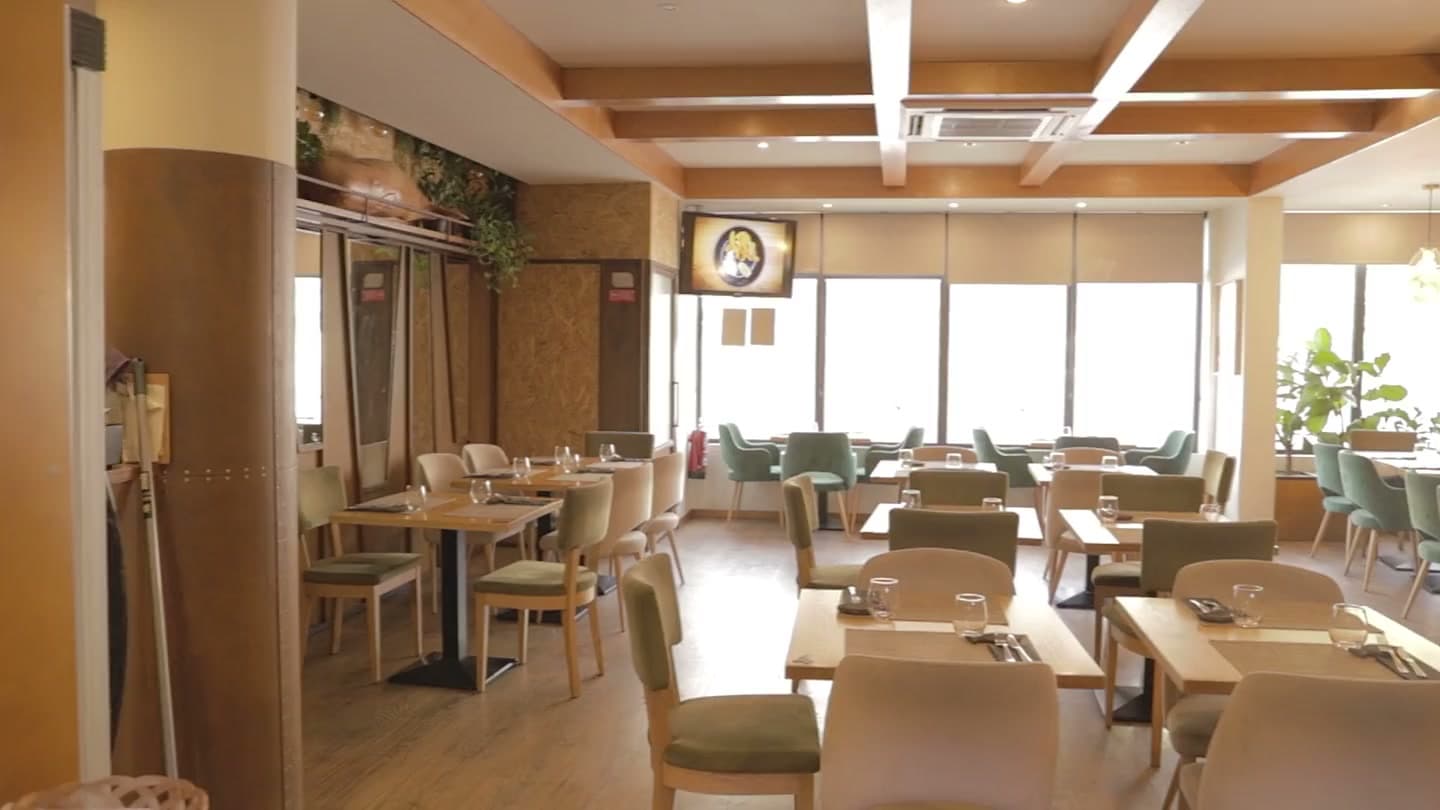 A dining room laid up before service, the camera moving slowly through it