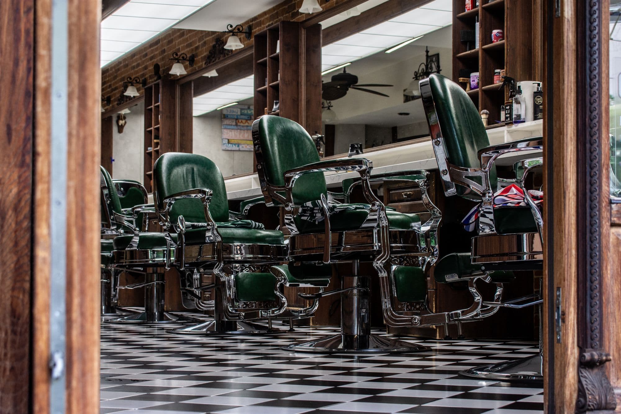 Barber chairs along a tiled floor